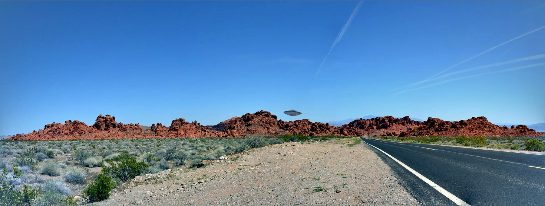 UFO hovering over mountain and highwy